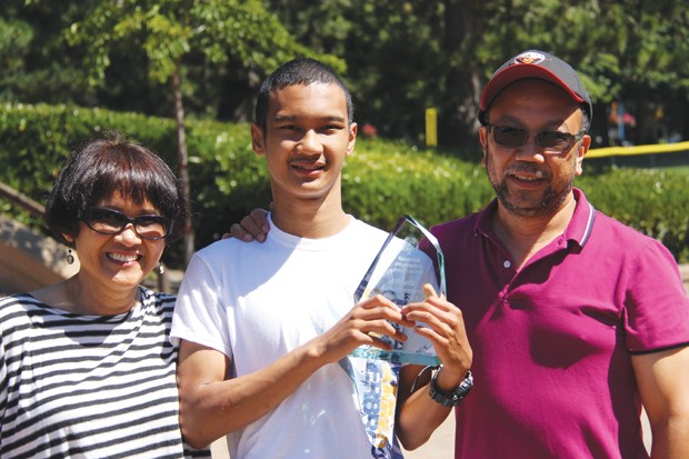 Richmond’s Magnus Batara shows off his Athlete of the Year award, flanked by his mom and dad, Dayan and Mario. Photo submitted