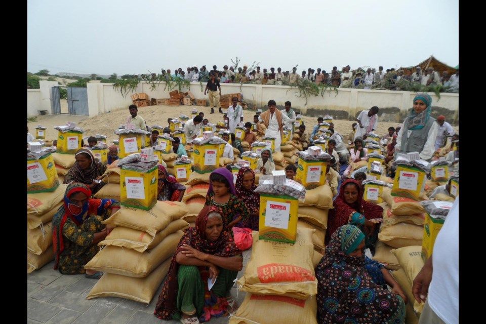 Packages of flour, rice, lentils, tea, sugar, dates, matches and cooking oil, ready for distribution.