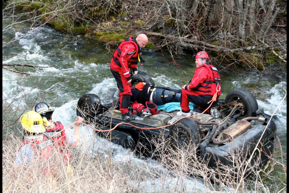 Christina Lake Fire and Rescue personnel prepare to extract Burnaby’s Frank Barbosa from an icy Kootenay stream in April 2013.