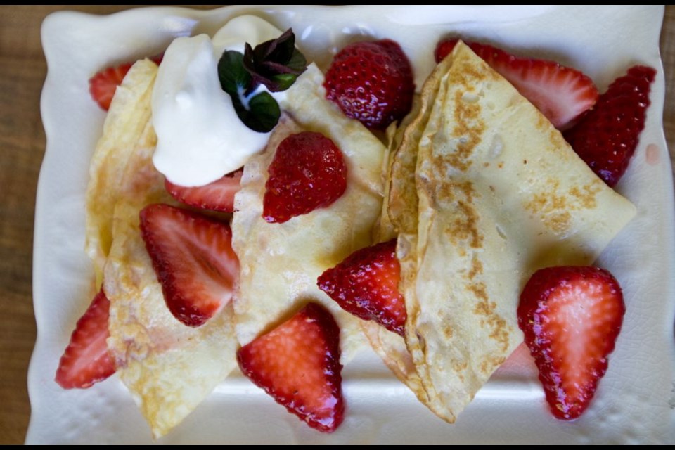 Orange liqueur-laced strawberries top the crepes in this elegant dessert.