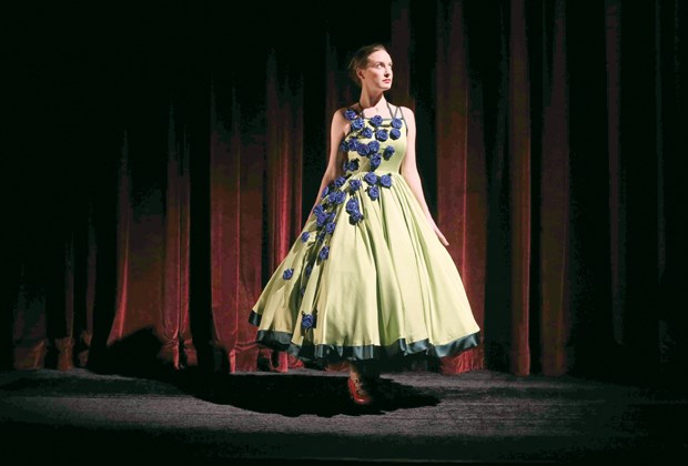 Bronwyn Malloy wears a green charmeuse gown with blue rosettes, inspired by astrocytes growing in a