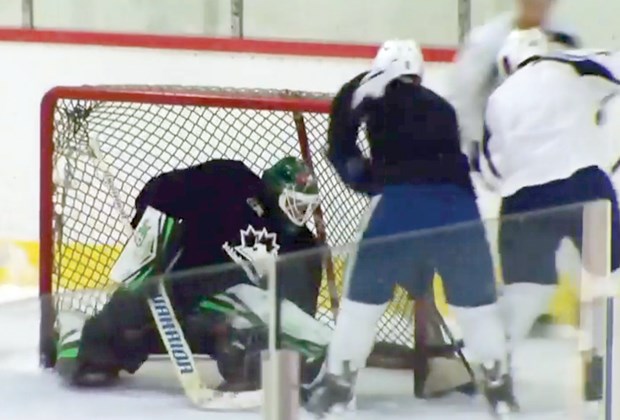 North Vancouver beer league goalie Tristan Jones makes a save during a practice session with several members of the Vancouver Canucks. Jones joined the fun after responding to a Twitter request. Screen shot CTVNews.ca