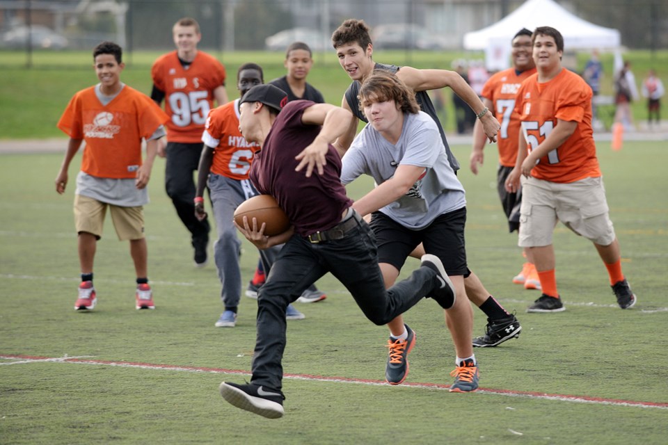 Aldrin Asuncion plays touch football with the junior varsity squad. Photo: Jennifer Gauthier