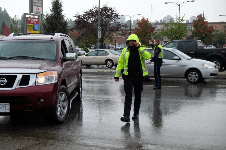 Const. Jaspaul Chung instructs a driver to pull over after being spotted using an electronic device while driving northbound on McBride Boulevard.