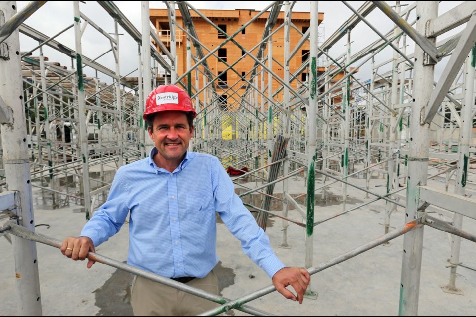 Lloyd Wansbrough, vice-president of construction for Metropolitan Capital Partners, stands inside the framing for a hotel the company is building in Colwood. It's part of a development at Wale and Wilfert roads that includes a rental building next to the hotel.
