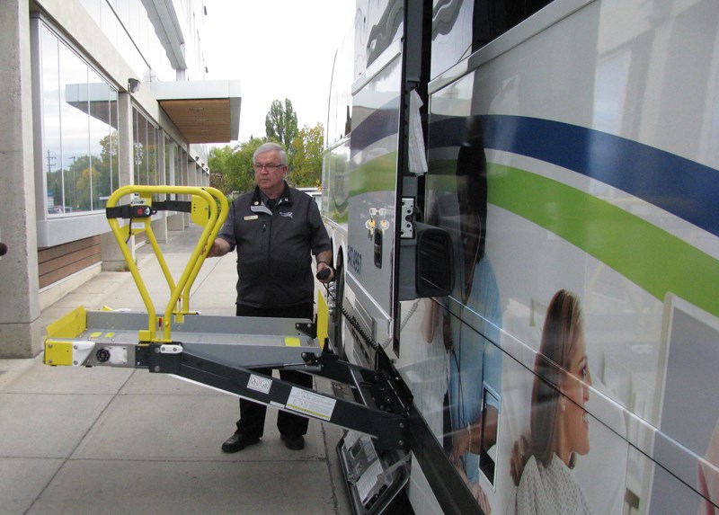 Bus driver, Richard Banks, demonstrates the new wheelchair access system on the Northern Health Connections bus that was just added to the fleet.