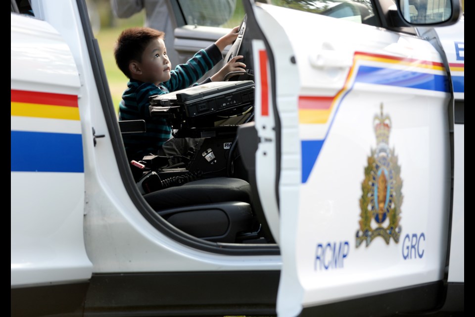 A youngster checks out one of the police cruisers at the Burnaby RCMP open house on Saturday.