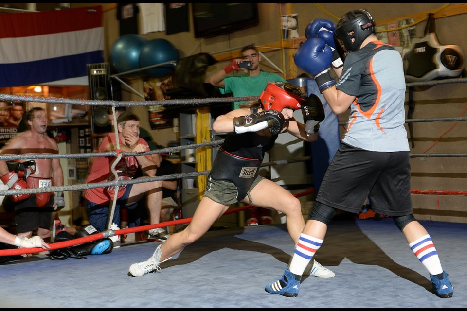 On the ropes: Rosalia Calla (red headgear) takes a swing during her training at Burnaby North Boxing Club. Robert Couzens and Calla are heading – along with three other fighters from their club – to the World Boxing Council amateur Canadian championships later this month.