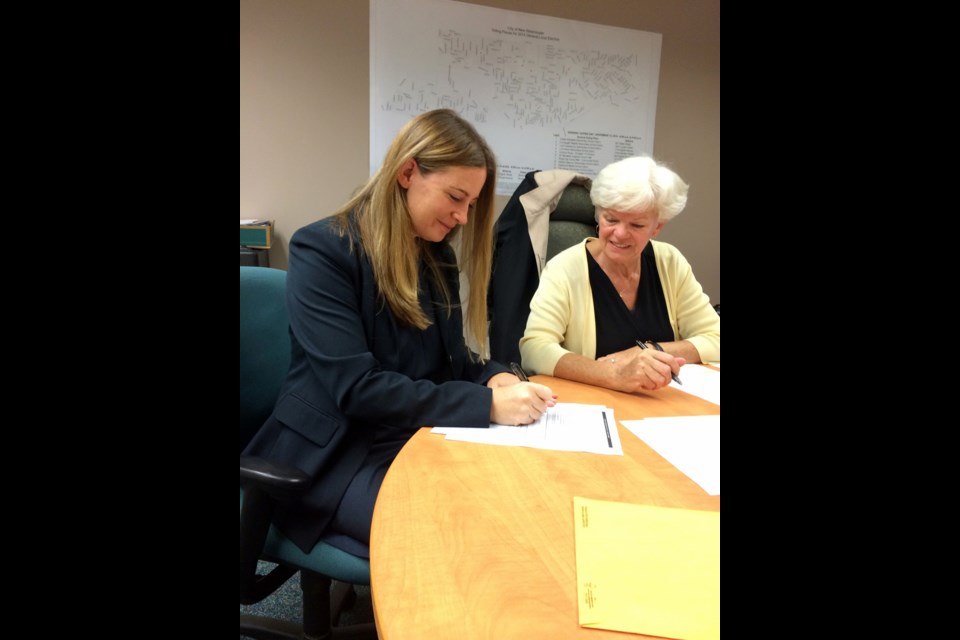 School board candidate Kelly Slade Kerr was the first to file nomination papers in New Westminster for this year's civic election, as chief election officer Isabell Hadford looks on.