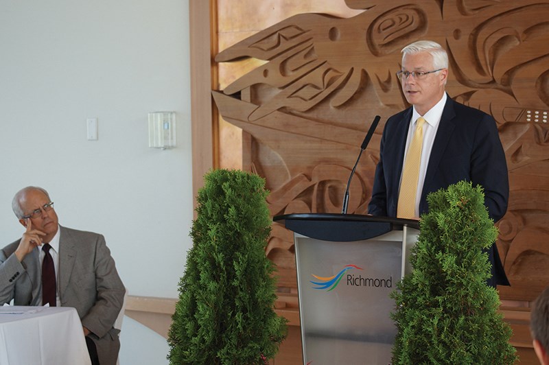 Craig Richmond of YVR speaks as Richmond Mayor Malcolm Brodie listens. Richmond says YVR needs to become an international hub. Oct. 1, 2014.