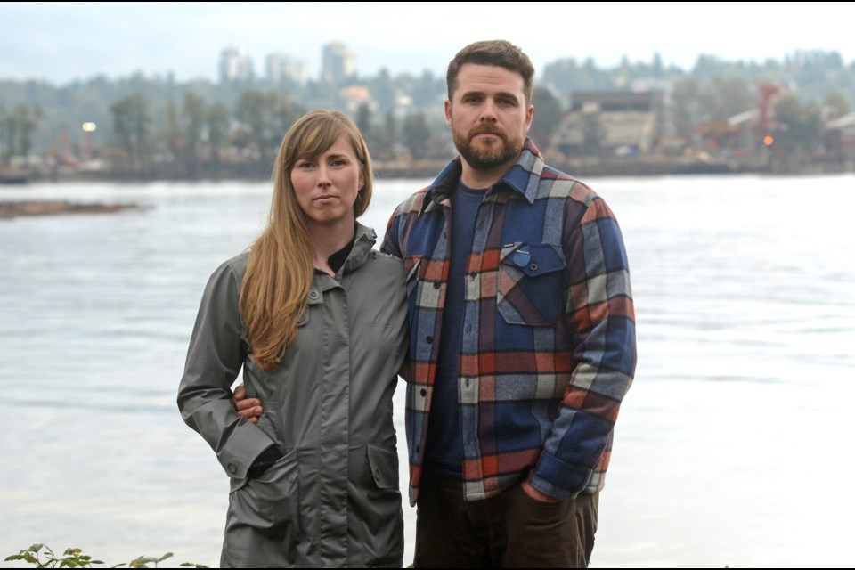 New Westminster residents Jen and Joel Harding stand across the Fraser River from Schnitzer Steel, a company they say is keeping them awake into the wee hours of the morning.