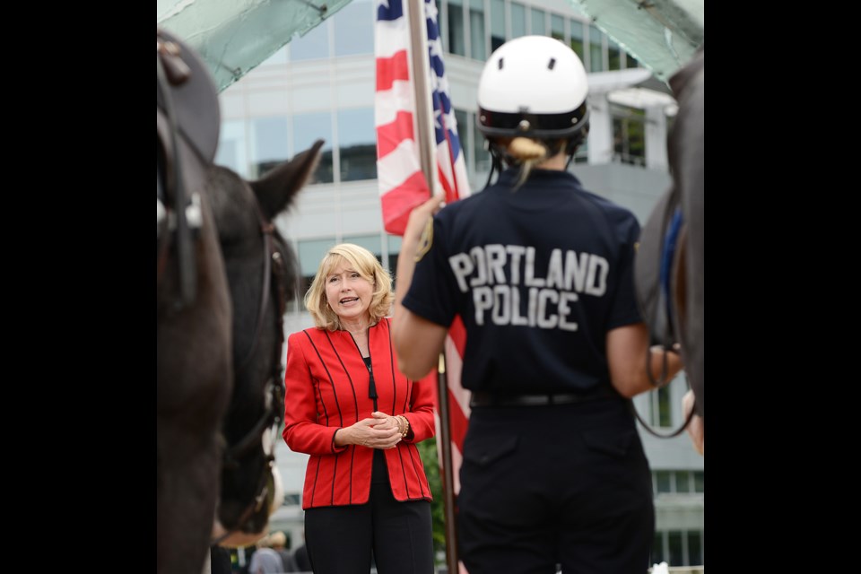 U.S. Consul General Lynne Platt speaks with the police officers from Portland, Seattle and Vancouver at Jack Poole Plaza Friday afternoon after a week-long Police Mounted Unit seminar. Photo Dan Toulgoet