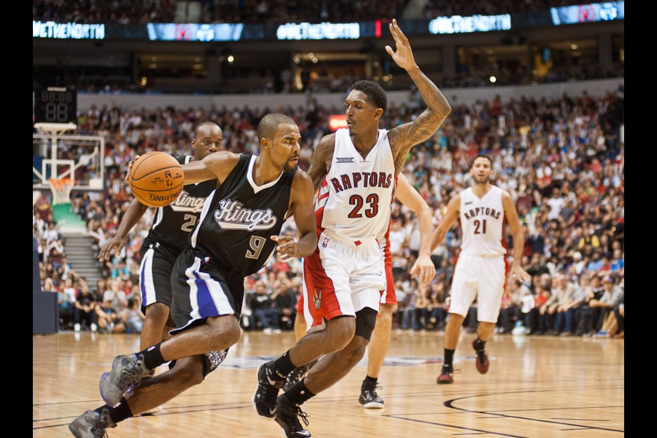 Raptors Louis Williams defends against Ramon Sessions in a pre-season game between the Toronto Raptors and Sacramento Kings at Rogers Arena on Oct. 5, 2014. Photo Rob Newell