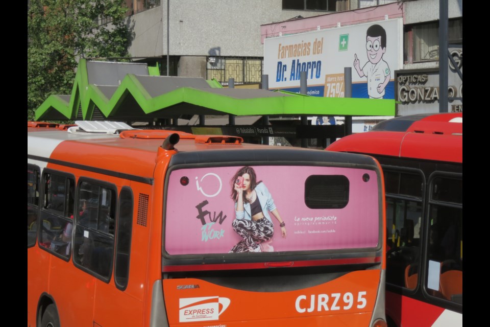 At some Santiago bus stops, passengers pay on the platform in order to speed up pick up and drop off. Photo Michael Geller