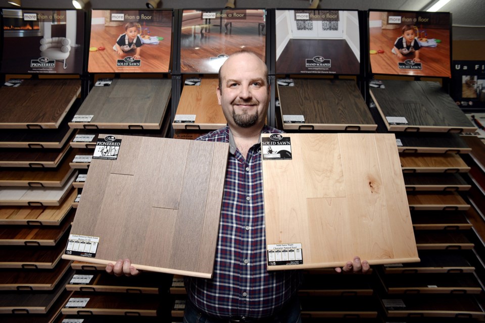 Knock on wood: Casa Madera owner and manager Peter Pocrnic shows off some of his shop’s hardwood samples. The boutique hardwood flooring store is celebrating 10 years in the Heights this year.