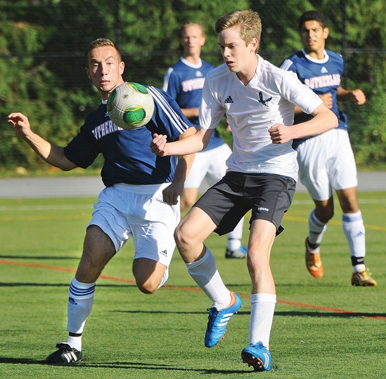 Sutherland's Dzenan Bezdrob races Carson Graham's Pedro Steinhoff during senior soccer exhibition action last week. Sutherland won 4-1, kicking off their campaign to defend the provincial AAA title they won last year.