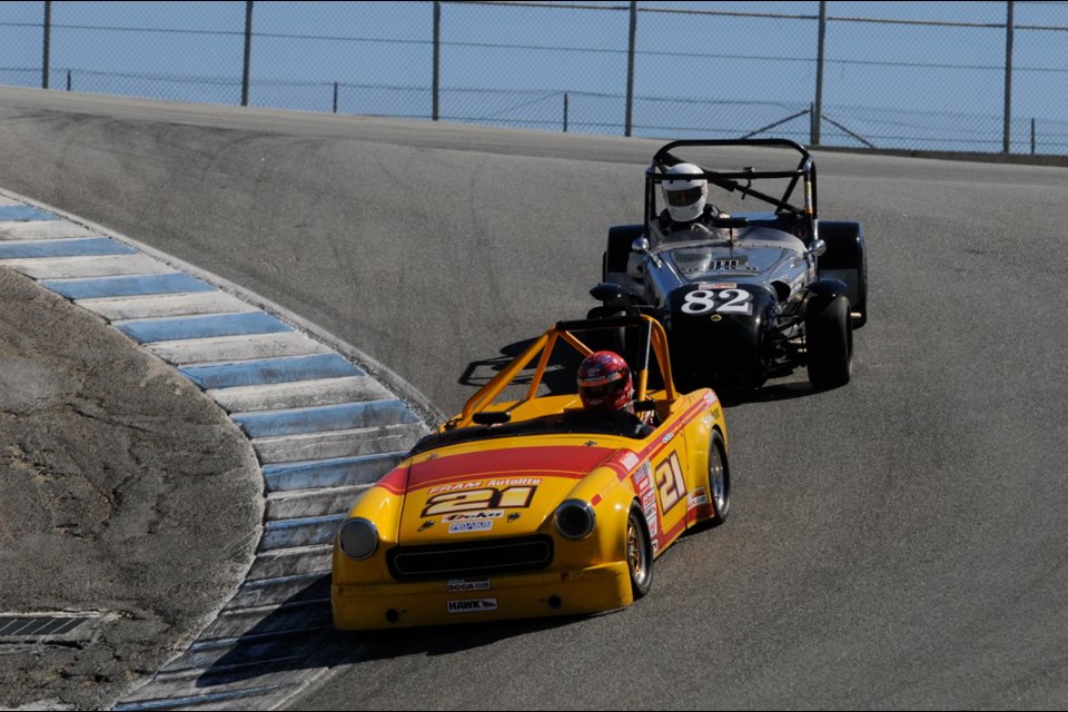Bill Okell, No. 21, carves through the "Corkscrew" turn during practice at Laguna Seca in 2014.