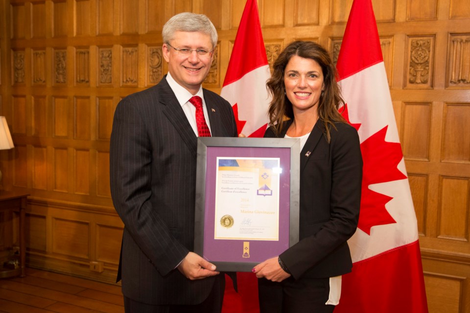 Brentwood Preschool early childhood educator Marina Giovinazzo accepts a certificate of excellence from Stephen Harper at the 2014 Prime Minister's Awards in Ottawa Oct. 7.