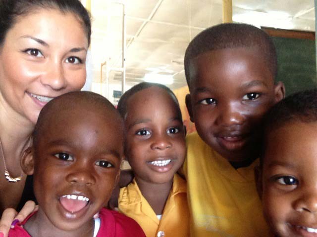 Ayako Turnbull, co-founder of Fundamentals for Change, with some of the kids she helps at the Riverton school in Kingston, Jamaica