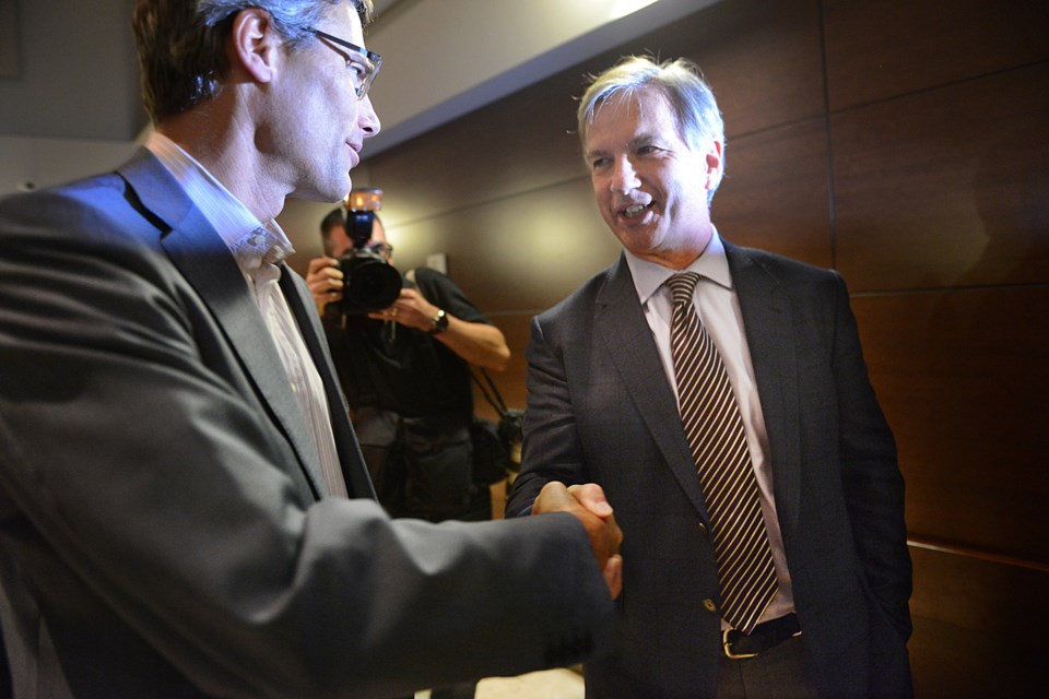 Mayor Gregor Robertson and NPA mayoral candidate exchange handshakes before speaking to more than 600 people at the Italian Culture Centre Thursday on what they would do to improve transit, affordable housing, poverty and social isolation. The Metro Vancouver Alliance organized the forum. Photo Dan Toulgoet