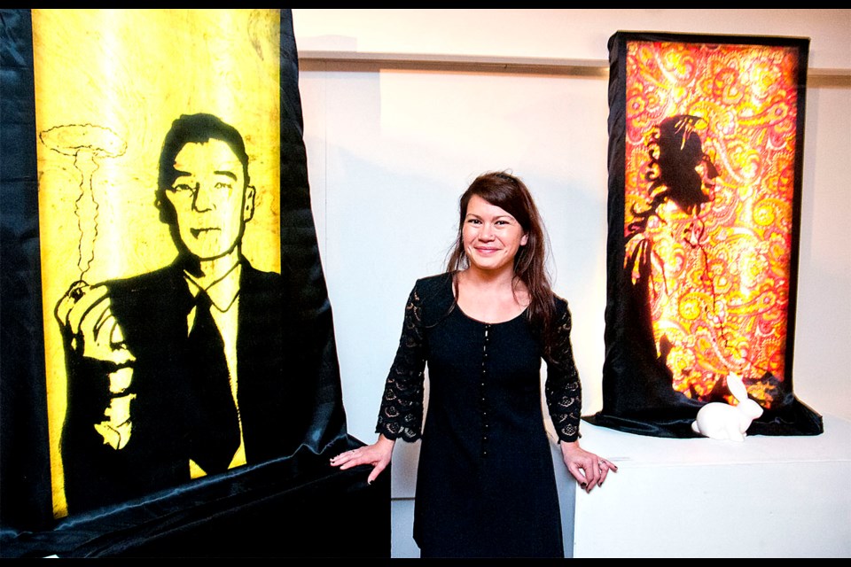Gillian Worsley with some of the illuminated work on display in From Darkness Comes Illumination, on now at the Burnaby Arts Council's Deer Lake Gallery.
