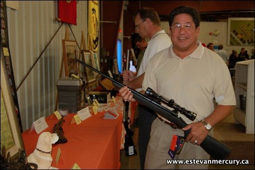 Dean Chow attended the annual Estevan Wildlife Federation fundraising dinner and admired one of a few rifles that were up for silent auction bids during the course of the evening.