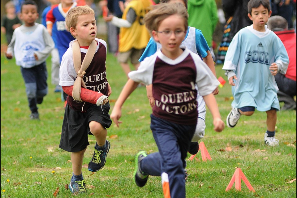 A broken arm didn't keep Gabe Pullen, a Grade 1 student at Queen Victoria elementary, from running in the cross-country meet at Trout Lake on Oct. 21, 2014. Photo Dan Toulgoet