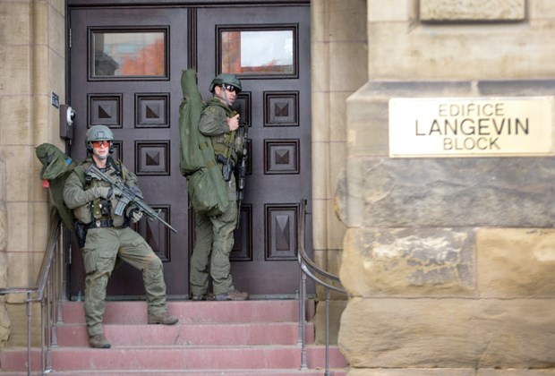 RCMP tactical officers attempt to enter the Langevin Bloc on Parliament Hill.