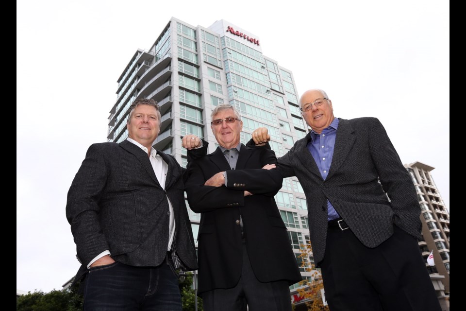 The principals of Campbell Construction, from left, Archie Campbell, Ken Farey and Wayne Farey, in front of the Marriott Inner Harbour Hotel, one of the many projects the company has built over the last decade. Campbell Construction is celebrating its 50 anniversary this year.