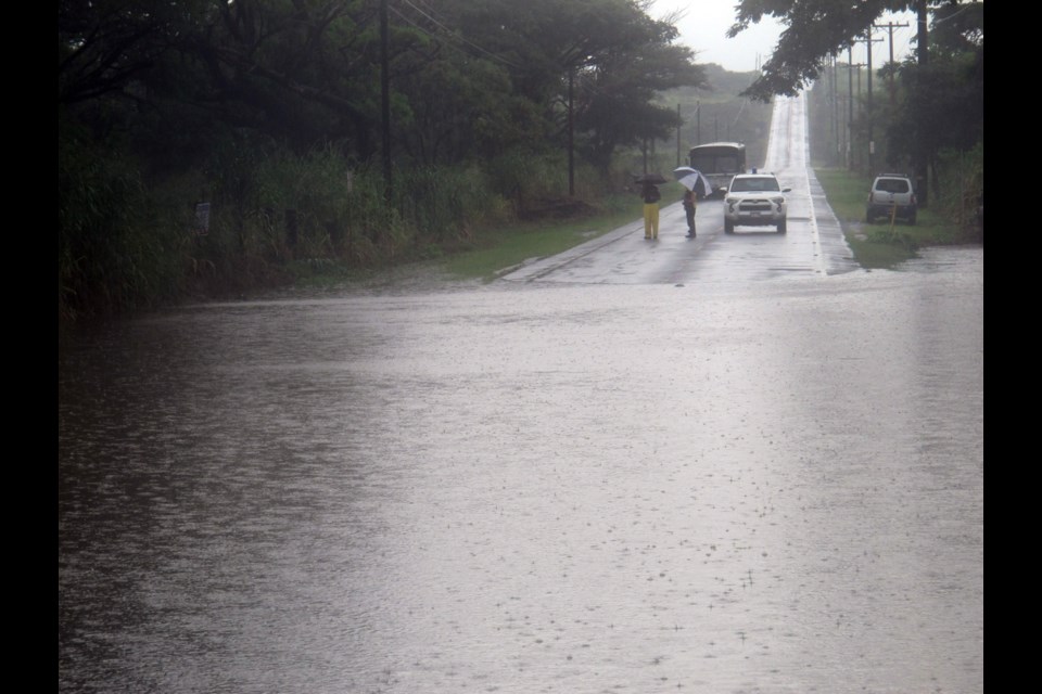 A county bus is stranded on Highway 11 in Naalehu, Hawaii where heavy rains from hurricane Ana flooded the road on Saturday, Oct. 18, 2014. The remnants of the hurricane are expected to hit the B.C. coast on Monday and Tuesday.