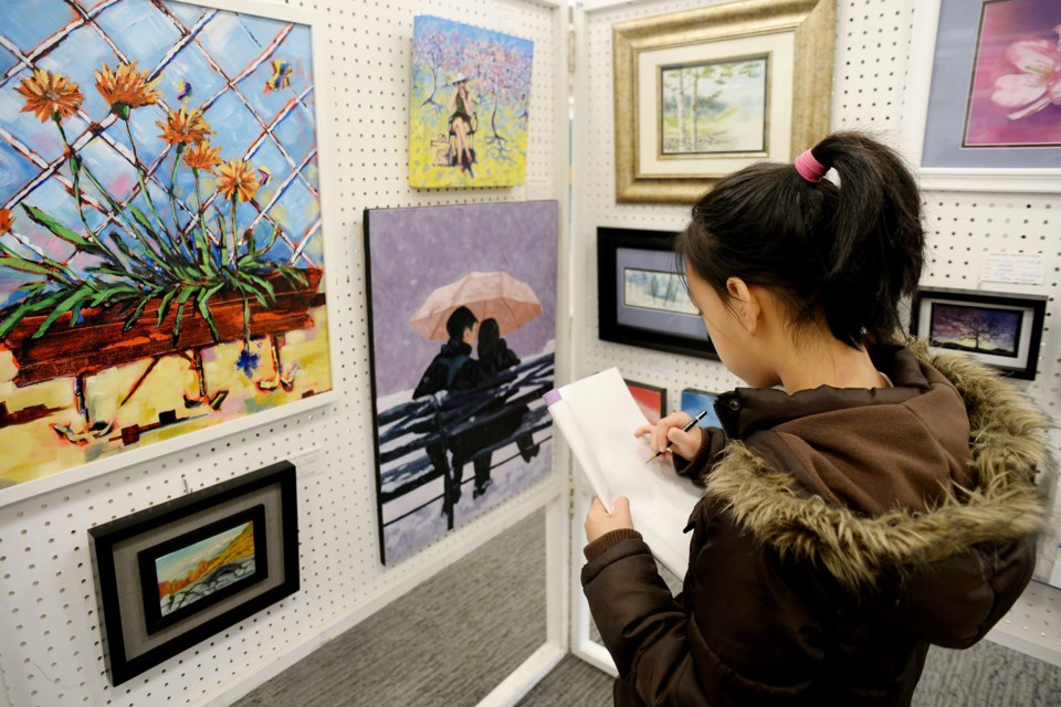 Kristen Nguyen, a student in the Studio F drawing course, checks out the Burnaby Artists' Guild's fall show and sale at the Shadbolt Centre on Saturday.