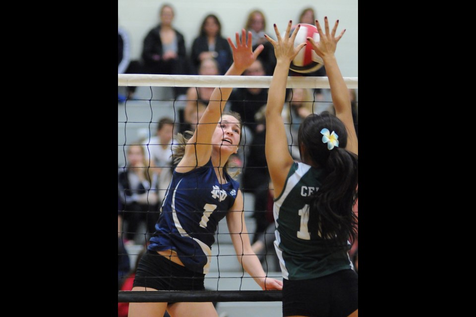 Notre Dame's Mia Ricci (No. 1) hits the ball against St. Pat's blocker Beatrice Soberano (No. 10) during a quarterfinal match in B.C. Catholics championship at Notre Dame secondary Oct. 24, 2014. St. Pat's won the game and the tournament title. Photo Dan Toulgoet