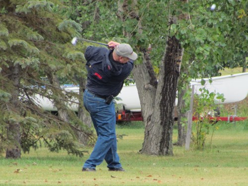 Phil Harrison powers out of the light rough on the first hole at Carlyle Golf Course. (Note the ball, top right.) The RCMP match was played on August 12.
