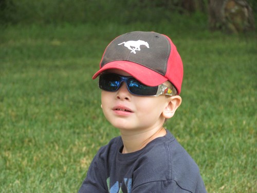 Aiden Ford, from Regina, relaxes for a moment while playing ball with his parents.