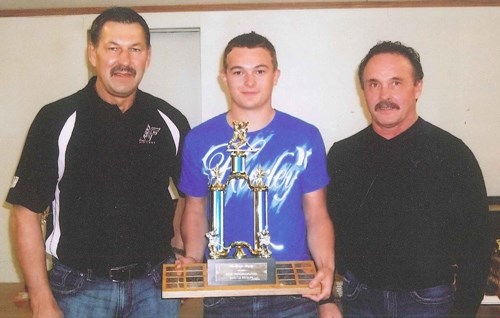 Levis Lawrence (center) receives the Most Improved Player Award from Allan Fleck (left) and Dewayne Geiger (right).