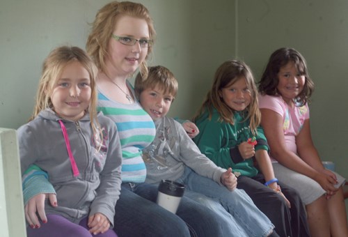 Camp instructor, Rachel Corrigan shows children around the train at Rusty Relics Museum.