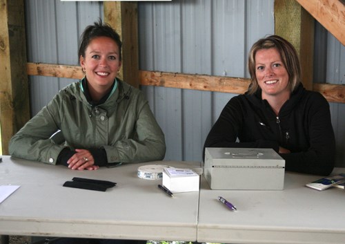 Danielle Benjamin and Natalie Miller sell tickets for the Sink or Swim auctions at Lions Park.