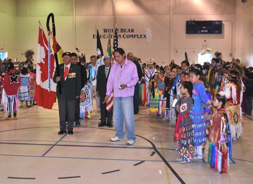 The Grand Entry flag bearers and dancers.