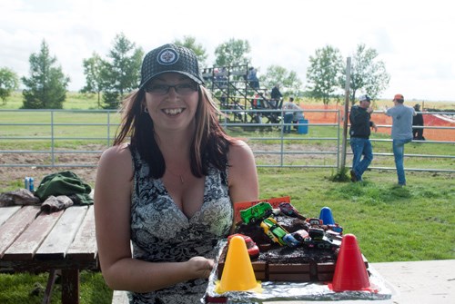 Nicole Denbow proudly displays the cake she baked, which was raffled off for $190.