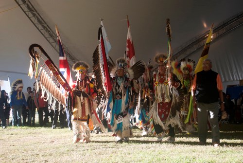 Flag Staff carriers mark the beginning of the Pow Wow during the Grand Entrance.