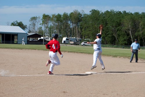 A Carlyle Cardinal is out on first after the Marysburg first baseman catches a high toss from the shortstop.