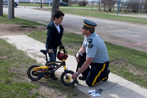 Cpl. Guider spoke with students about bicycle safety while teaching youth how to inspect their bikes and filled student&#8217;s tires.