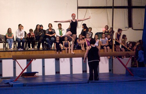 Abigail Birch performs on the balance beam.