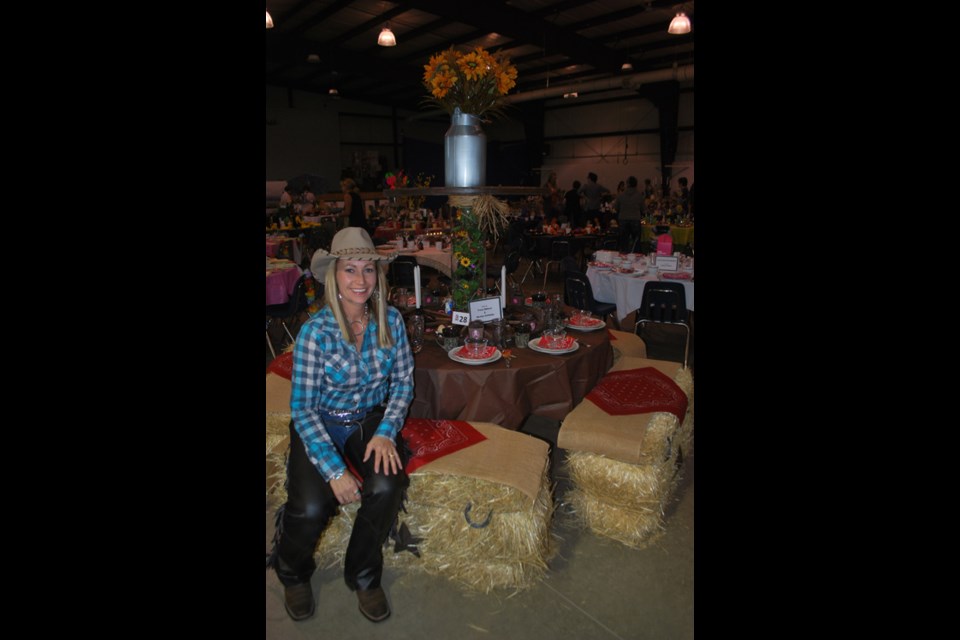 Tracy Nelson sits with, Monica Schlamp&#8217;s (not pictured) and hers, very original creation, complete with straw bales for chairs.