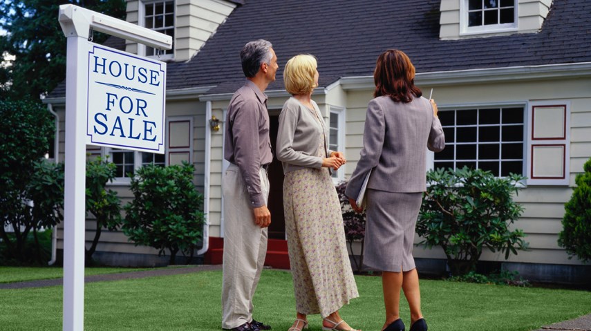 Couple viewing home with real estate agent