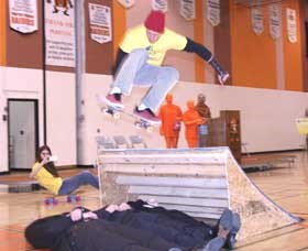 The official presentation of a $150,000 grant from the Aviva Community Fund was made Thursday at the Yorkton Regional  High School. The grant, which will by matched by the City of Yorkton will go toward construction of a new Skateboard, Bike and Walking Park on the former Brodie Street property. To highlight the presentation Nathan Grayston jumps over Aviva representative Joanne Lemna, local organizer Dave Nussbaumer and Mayor James Wilson.