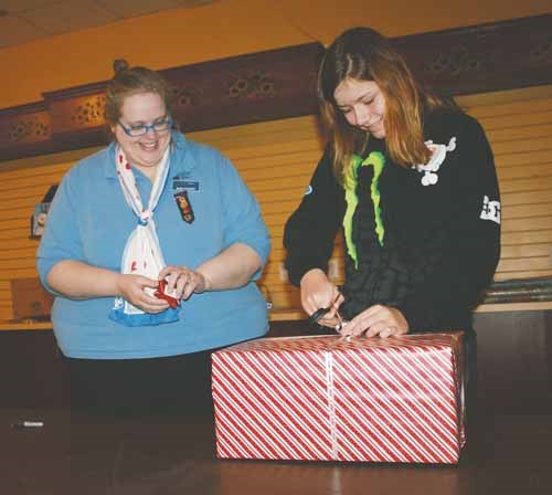 The Girl Guides of Yorkton are wrapping gifts at the Parkland Mall as a fundraiser. Here leader Barb Pohozoff, left, and guide-member Mya Desmarais wrap a present on Saturday. The service will be available Dec. 13-15, and 17- 23. Hours vary by the day, and are posted in the mall.