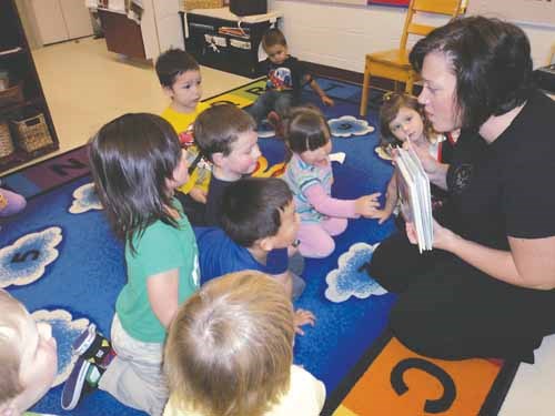 Darcie Krasowski, representative from the 鶹Ƶ East Reading Council, presents &#8220;The Gift of Reading&#8221; to students enrolled in the Pre-K programs at Columbia School. The council recently presented books to all the Pre-K students in Yorkton and surrounding areas.