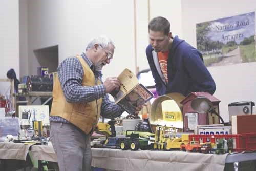 Jeremy Jamieson of Russell, Manitoba, chats with a customer during the St. Mary&#8217;s Last Chance Antique/Collectible Flea Market Saturday. The event offered a wide range of collectable items for those perusing the tables.