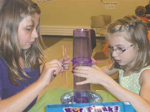 Lee-Anne, 10, and Chloe, 8 settle into a game of Ker Plunk at the Yorkton Public Library Friday. As part of the library&#8217;s summer programming, every Friday at 2 p.m. is game board day. All ages are welcome and pre-registration is not required.